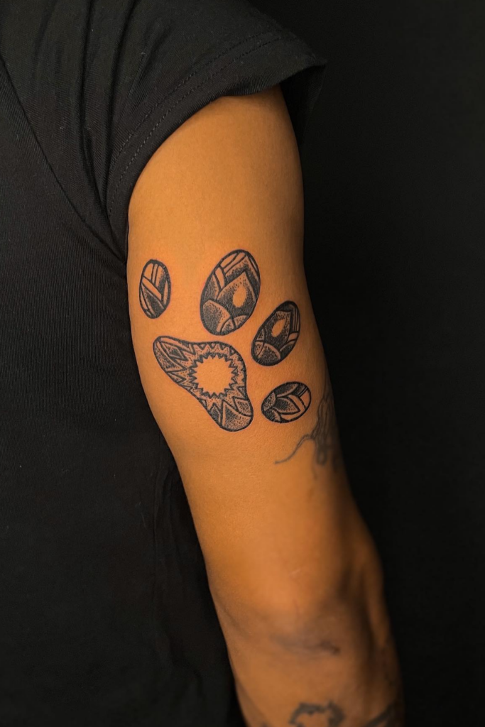 A man's right hand with a paw print tattoo