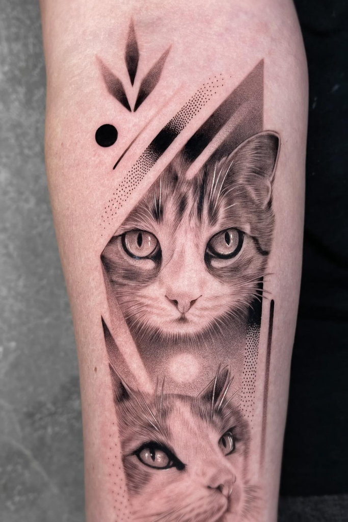 A clear tattoo of two cats of a person's arm