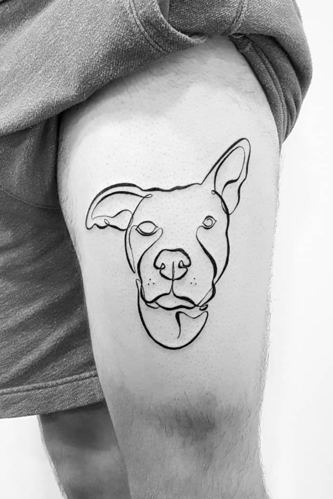 A large detailed, line art tattoo of a dog's face on a person's leg.