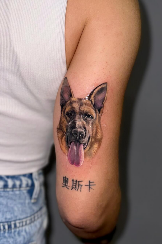 Dog portrait tattoo on the back arm
