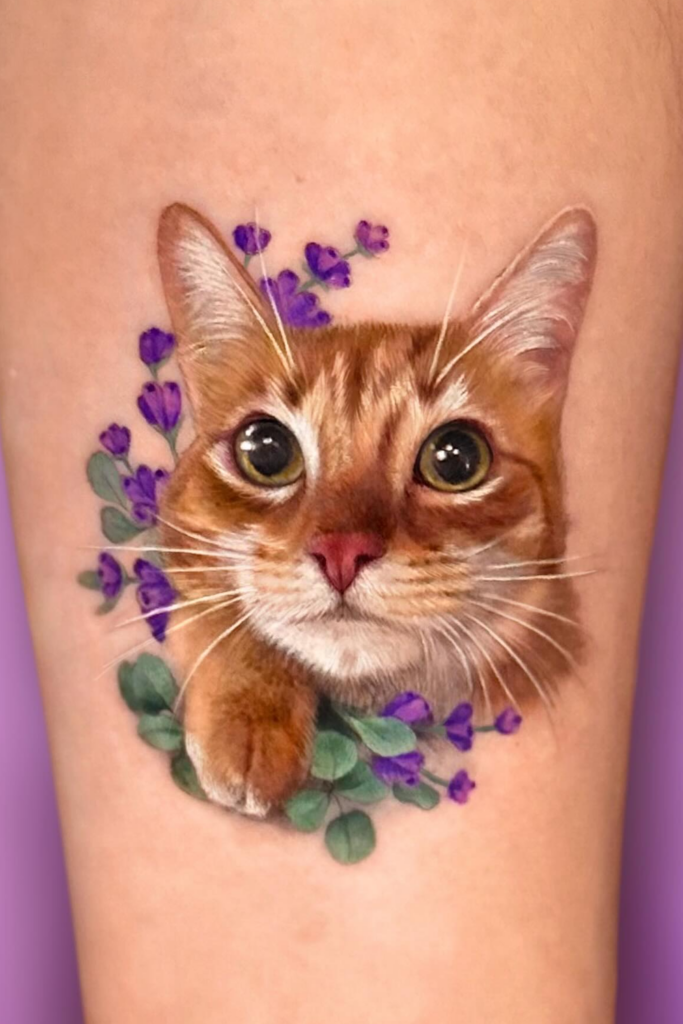 Kitten tattoo surrounded by eucalyptus and lavender