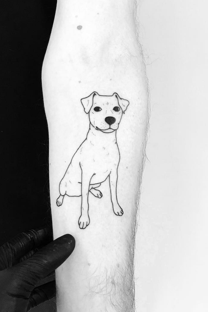 Minimalist line sketch tattoo of an adult dog on a person's left arm