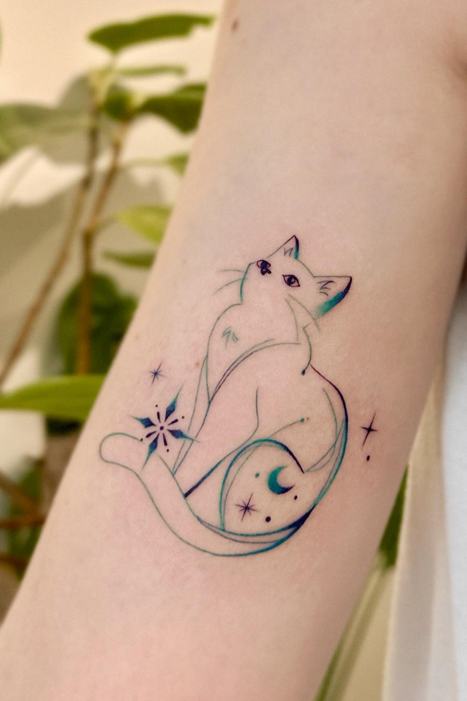 A minimalist cat tattoo on a person's arm
