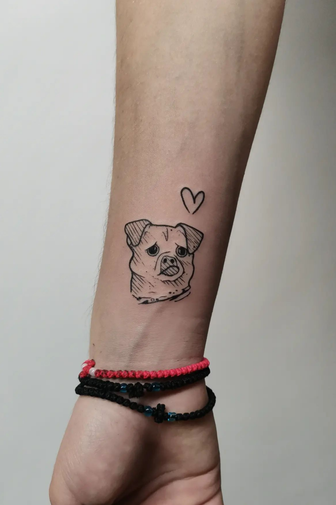 Simple line art tattoo of a dog's face.