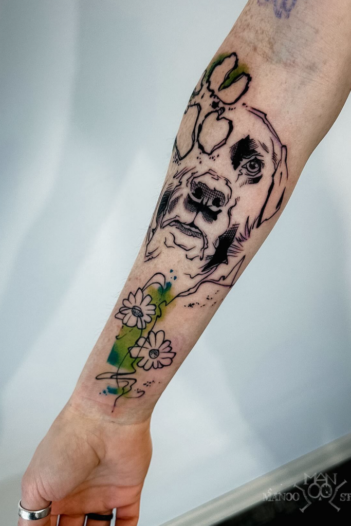 Sketch-style dog portrait tattoo on a person's arm