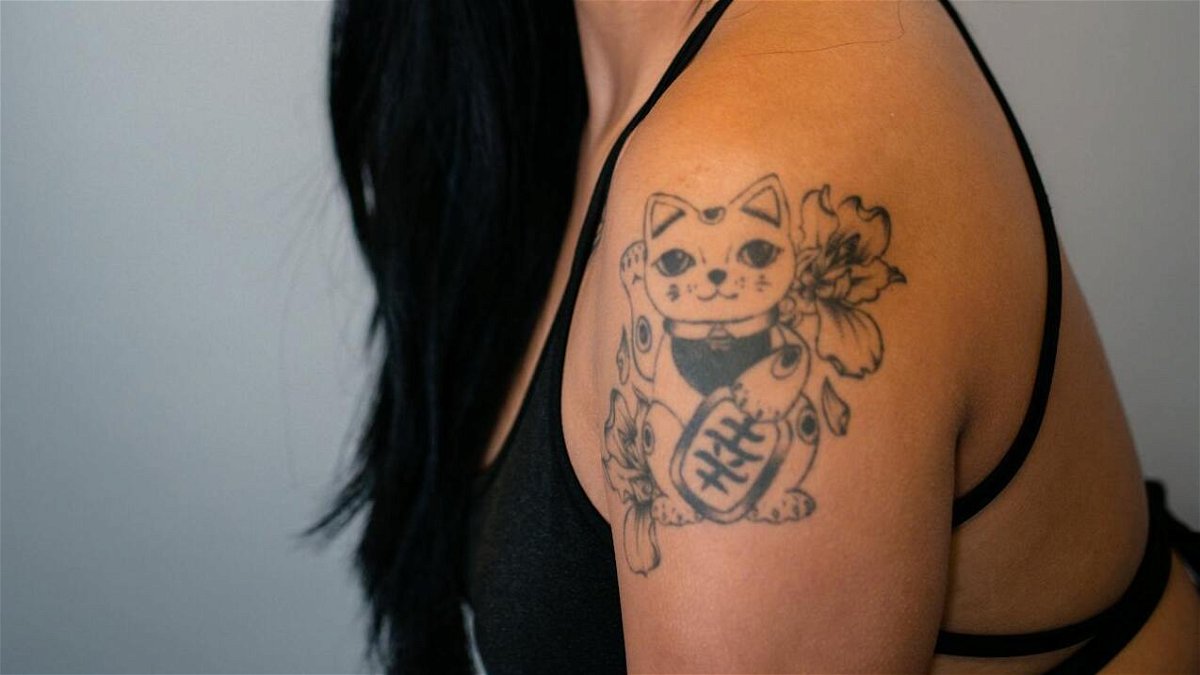 Cat Tattoo Ideas featuring a young woman with an arm tattoo